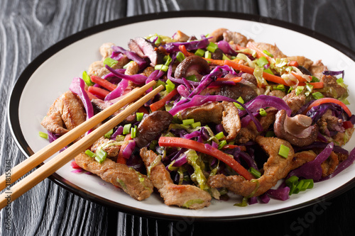 Chinese cuisine pork moo shu with vegetables and mushrooms close-up in a plate. horizontal