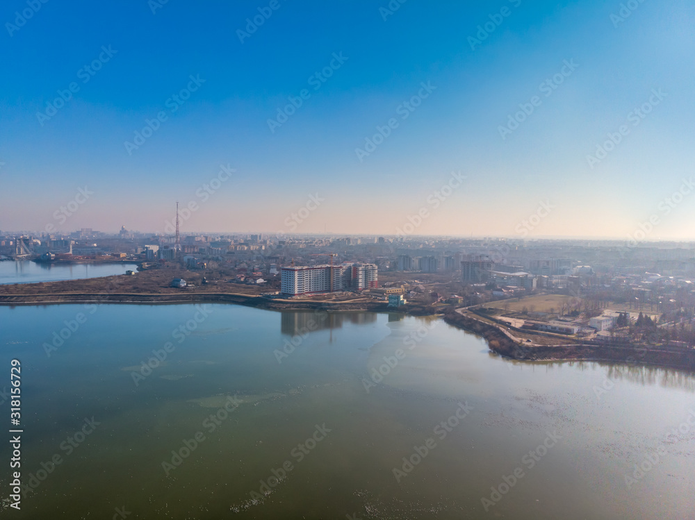 Aerial landscape photo of Morii Lake , Bucharest, Romania with many buildings in the distance.