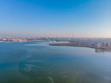 Aerial landscape photo of Morii Lake , Bucharest, Romania with many buildings in the distance.