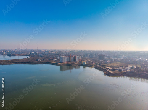 Aerial landscape photo of Morii Lake , Bucharest, Romania with many buildings in the distance.