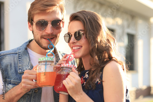 Beautiful young couple in love walking outdoors at the city street.