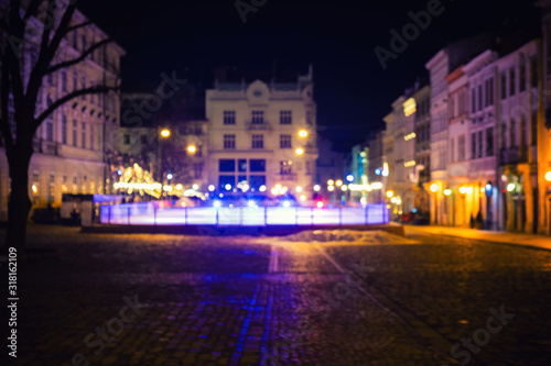 Out of focus image of old european city night street. Night street neon lights © Nickolay Khoroshkov