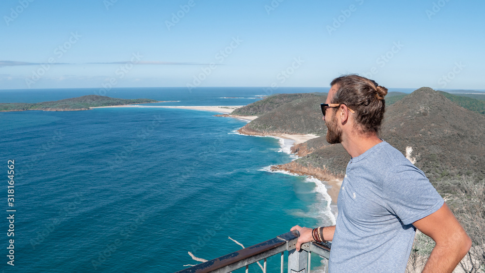 Man standing on the edge of a cliff viewpoint