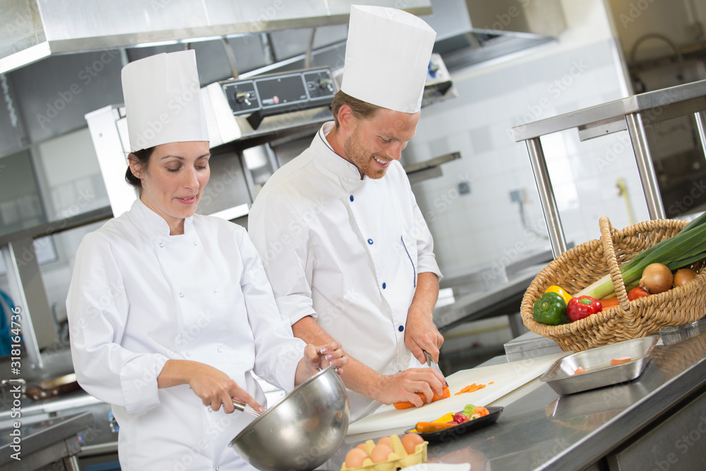 male and female chefs working together in professional kitchen male and female chefs working together in professional kitchen