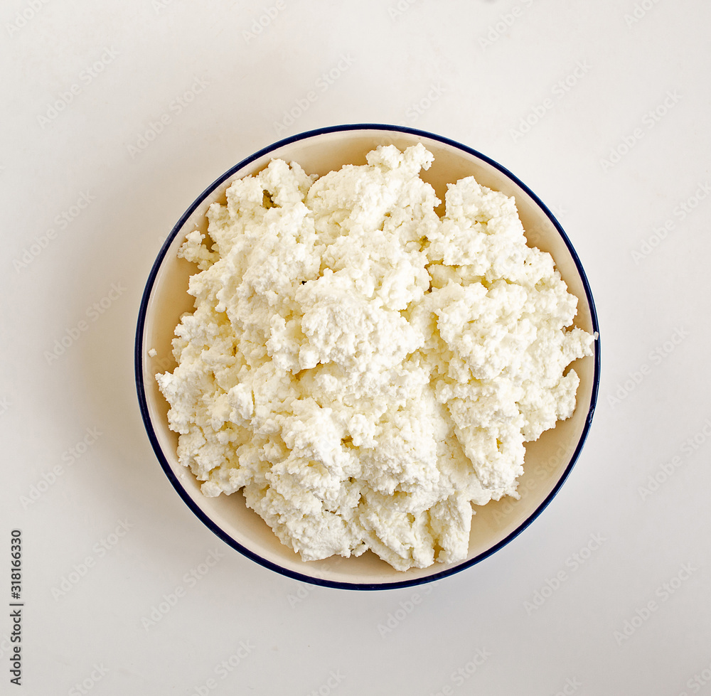 Farmer's cheese on white background from above Farmer's cheese on white background from above