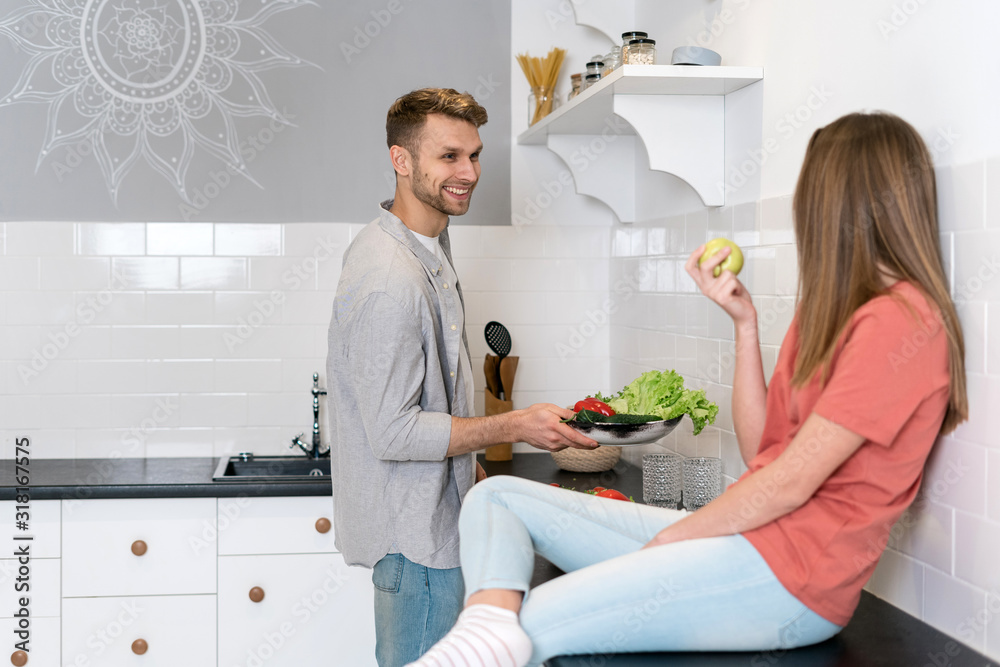 Young adult woman and man spending morning in kitchen Young adult woman and man spending morning in kitchen