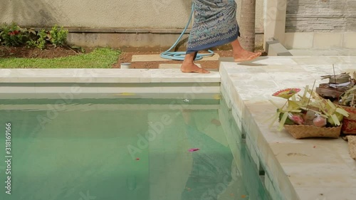 BALI INDONESIA - JANUARY 25 2019. Traditional indonesian hindu ceremony. Indonesian people celebrate pool construction. Women and men praying on the local villa. Tourism and travel concept photo