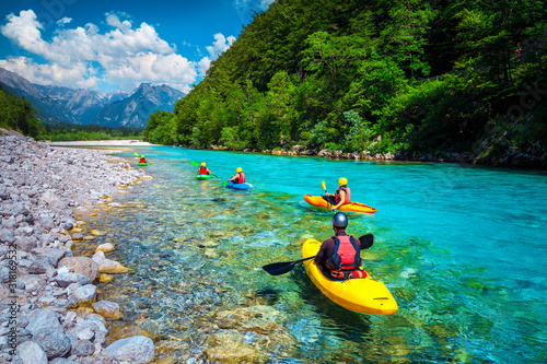 Sporty kayakers on the beautiful turquoise Soca river, Bovec, Slovenia