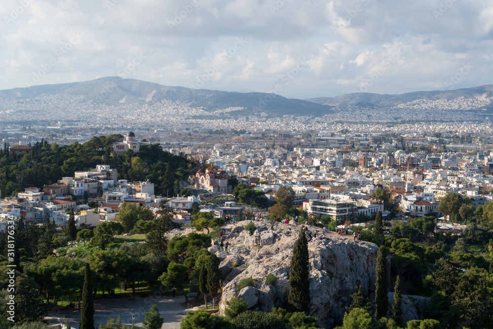 Athens, Greece - Dec 20, 2019: View from the Acropolis of the Athens skyline and the Areopagus (Ares Rock), under a hazy sky caused by dust clouds