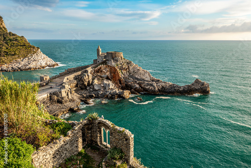 Rocks with San Pietro Church in Porto Venere town as seen from Doria castle. Ligurian coast of Italy.
