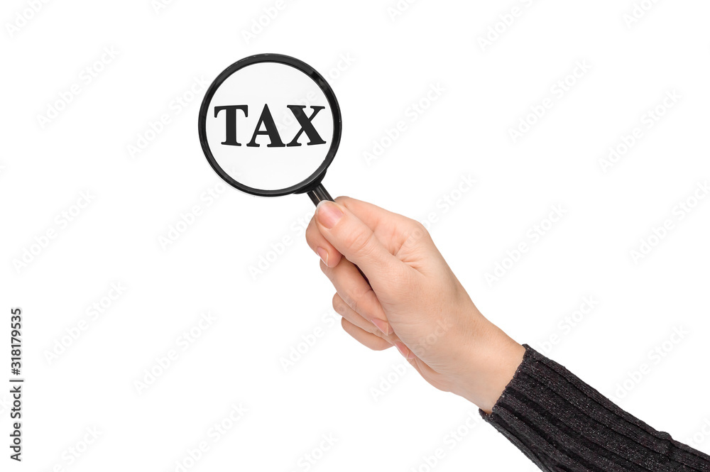 Hand showing tax word through magnifying glass. Isolated on white. Business concept. Hand showing tax word through magnifying glass. Isolated on white. Business concept.