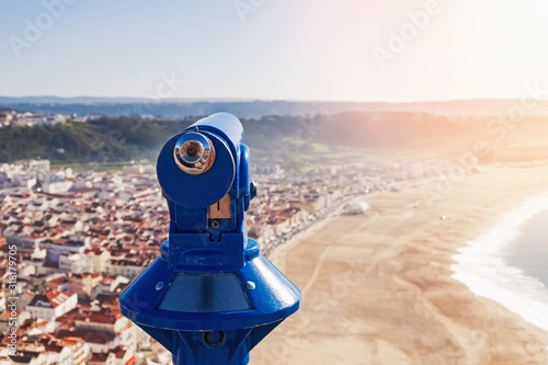Touristic binocular telescope looking on the city and beach.