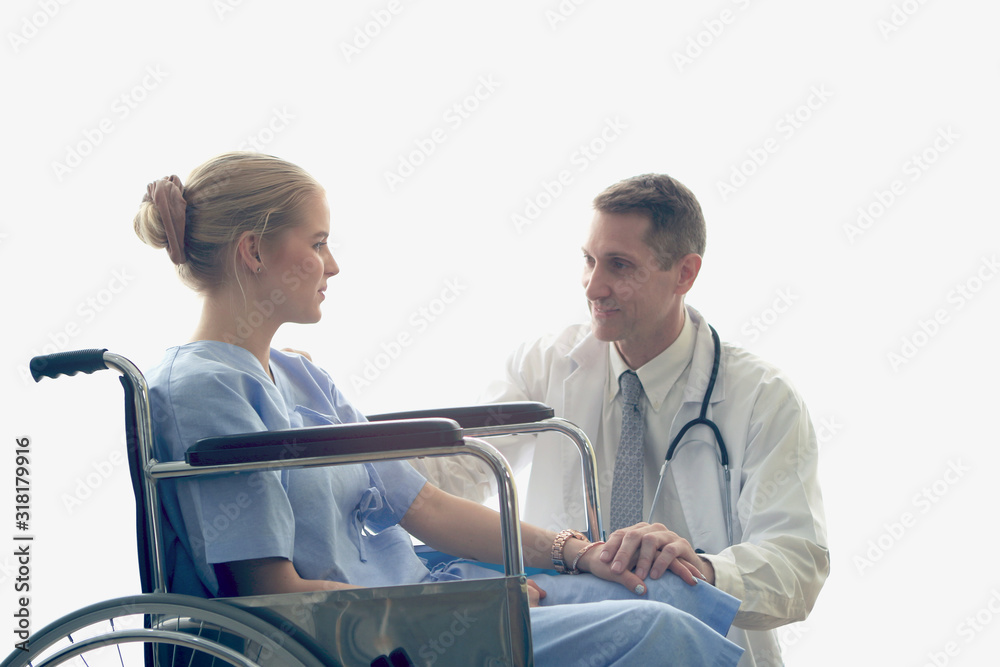 Doctor holding patient's hand who setting on wheelchair, doctor encourage and cheer up the patient to make her feel reassured and relaxed, health care and hospital concept Doctor holding patient's hand who setting on wheelchair, doctor encourage and cheer up the patient to make her feel reassured and relaxed, health care and hospital concept