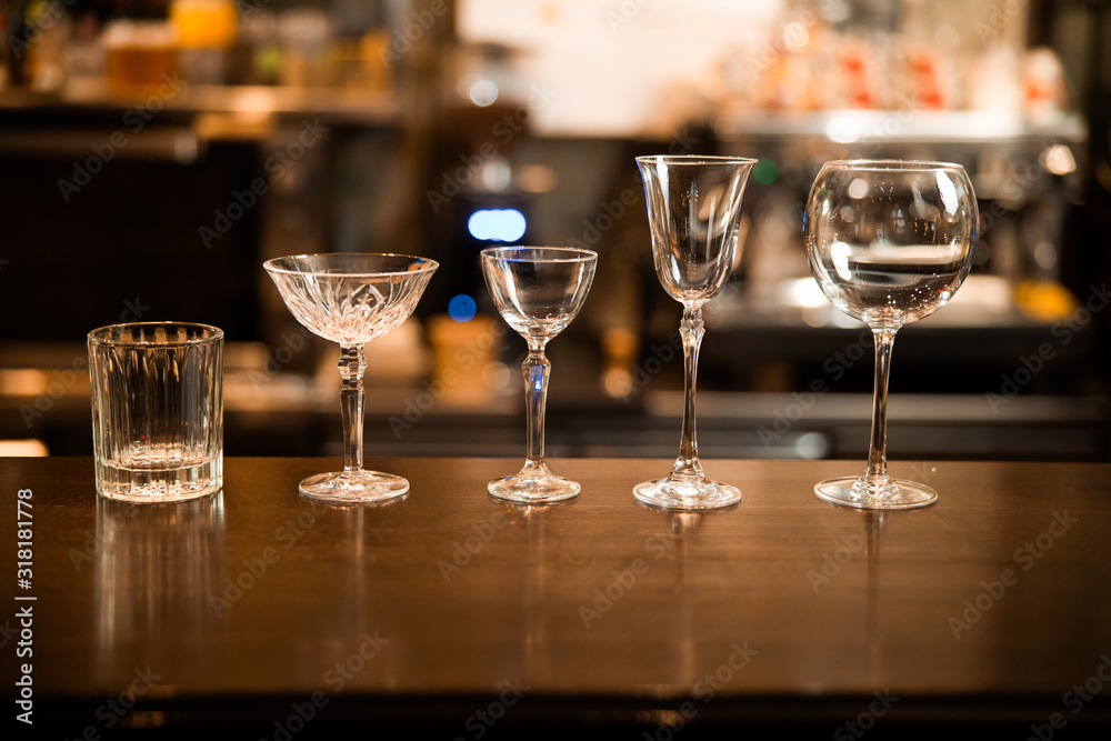 Empty clean glasses at the bar counter Empty clean glasses at the bar counter