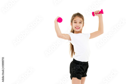 Little girl doing exercises with dumbbells.