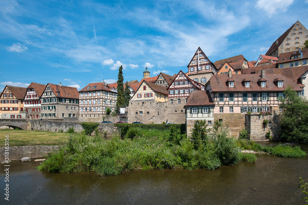 Schwäbisch Hall, Germany - July 25, 2019; City view with half timbered houses on the waterfront of a touristic town on the romantic road in Bavaria