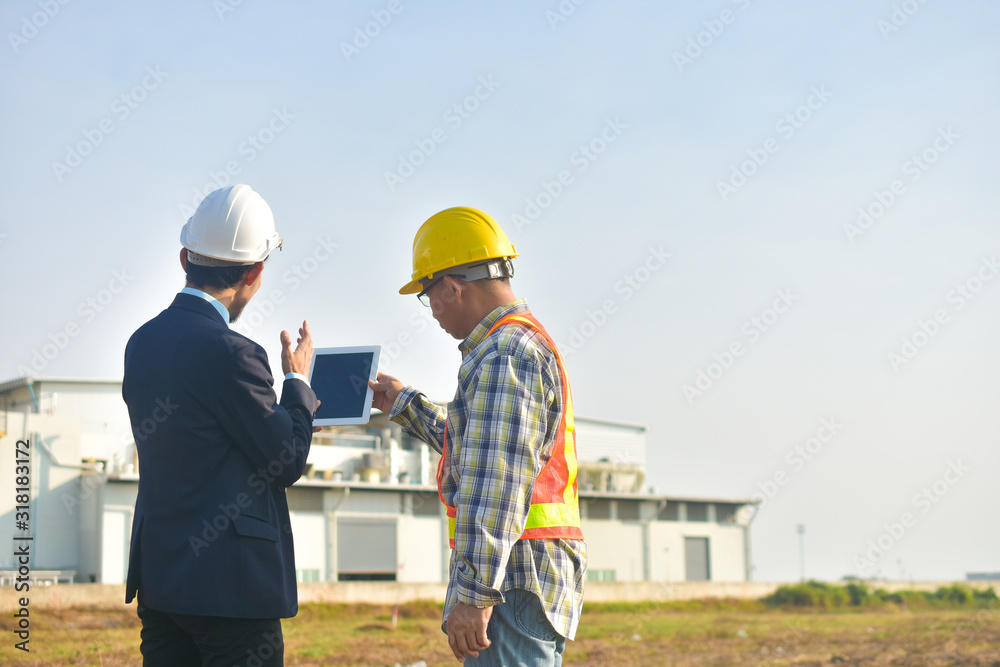 Project manager and Engineer communication use tablet factory background Project manager and Engineer communication use tablet factory background