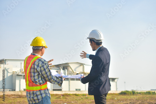 Project Manager taking with Engineer construction plan project building factory construction