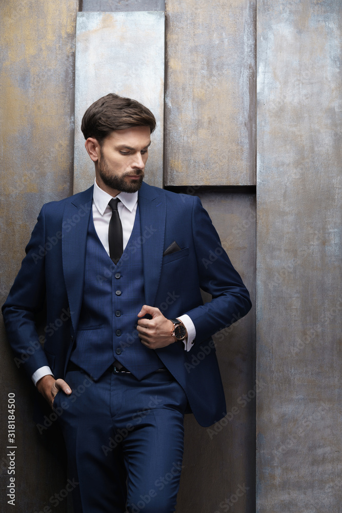 indoor photo of young handsome stylish businessman wearing suit indoor photo of young handsome stylish businessman wearing suit