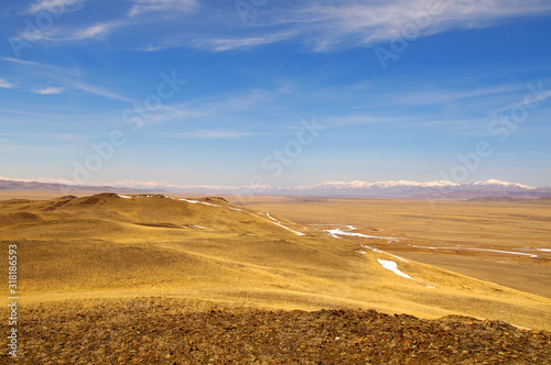 Orange steppe in the snow, Altai. Steppe landscape, nature. Far away view.