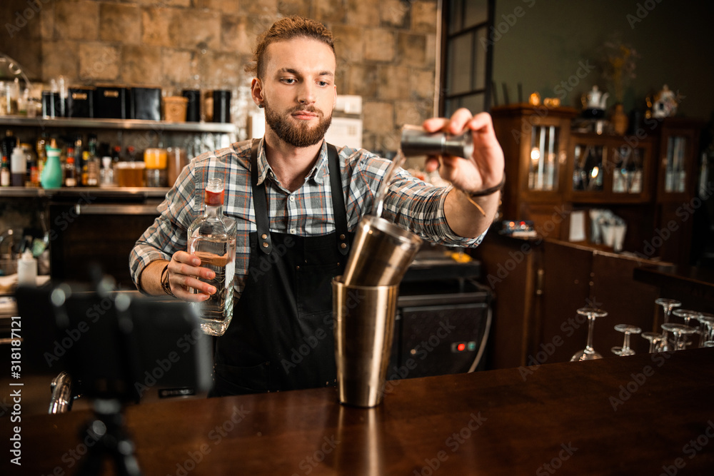 Professional bartender is recording vlog about cocktails