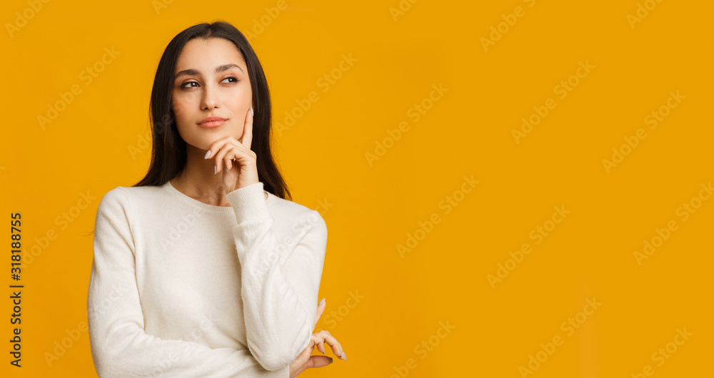 Εκτύπωση καμβά Pensive Brunette Girl Touching Her Chin, Thinking About Something
