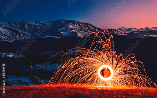 Burning Wirewool being used to make circle like light trails at Night on the Tarcu montain. Romania. Caras Severin.