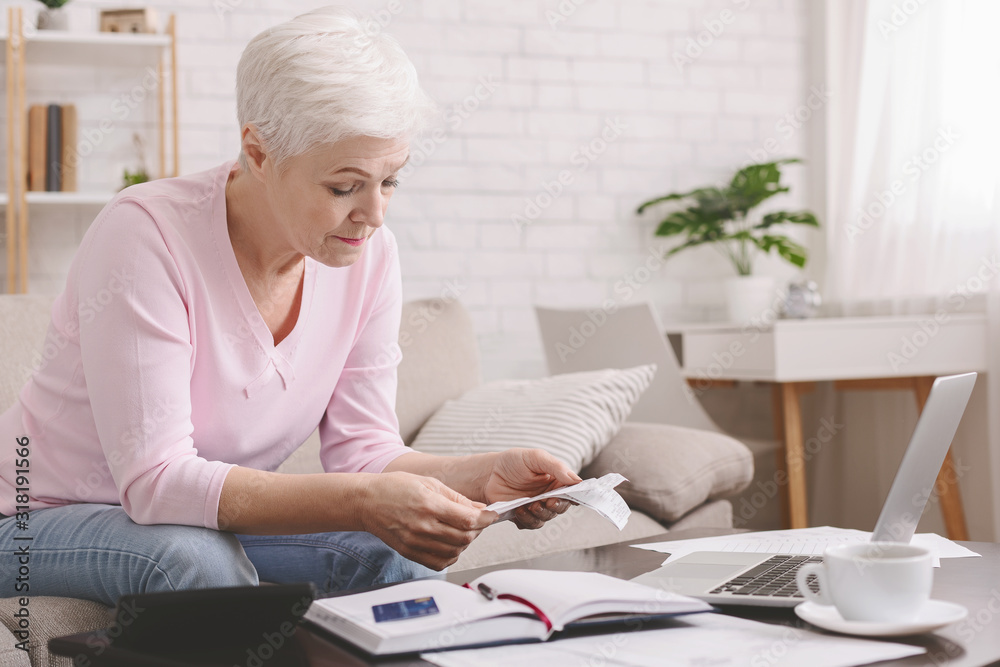 Senior lady counting finances and bills and home, empty space Senior lady counting finances and bills and home, empty space