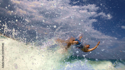 Bild auf Leinwand Surfer gets thrown off the surf board in a spectacular wipe out