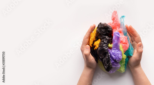 Woman hands holding a colored plastic bags in ball composition