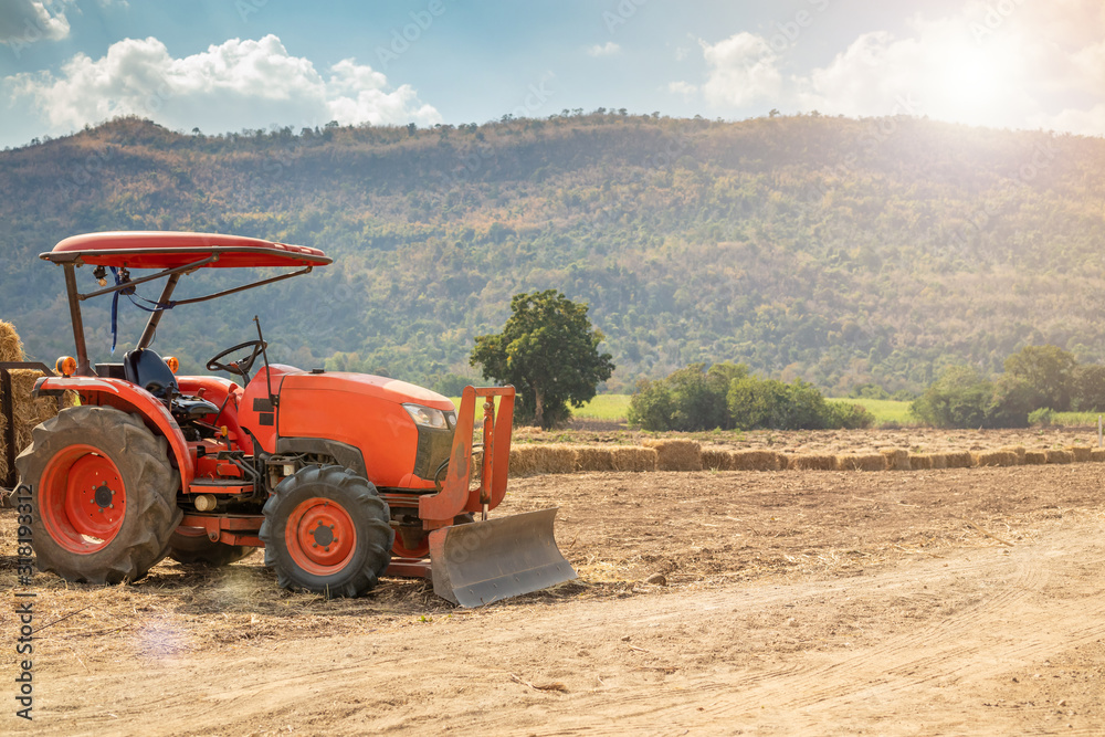 tractor in agriculture field with mountain and blue sky tractor in agriculture field with mountain and blue sky
