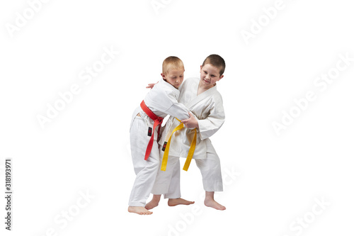 An athlete with a yellow belt makes a grab for the throw