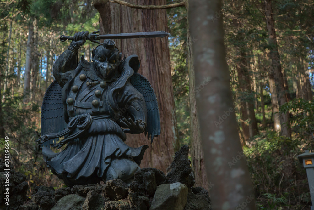 japanese mythology statue with sword on rocks japanese mythology statue with sword on rocks