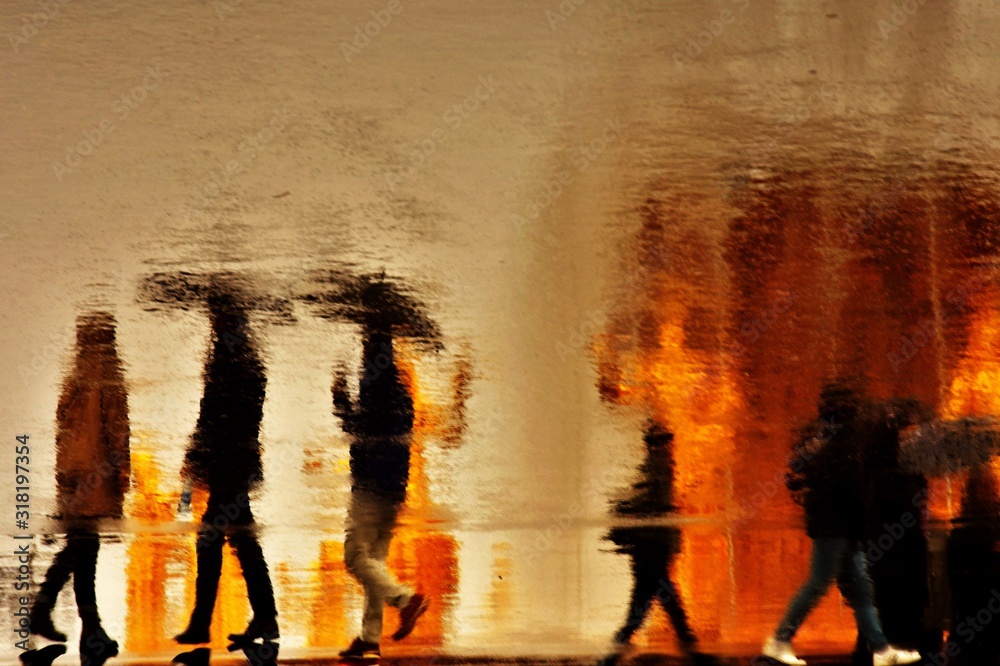 Blurred silhouettes of moving people