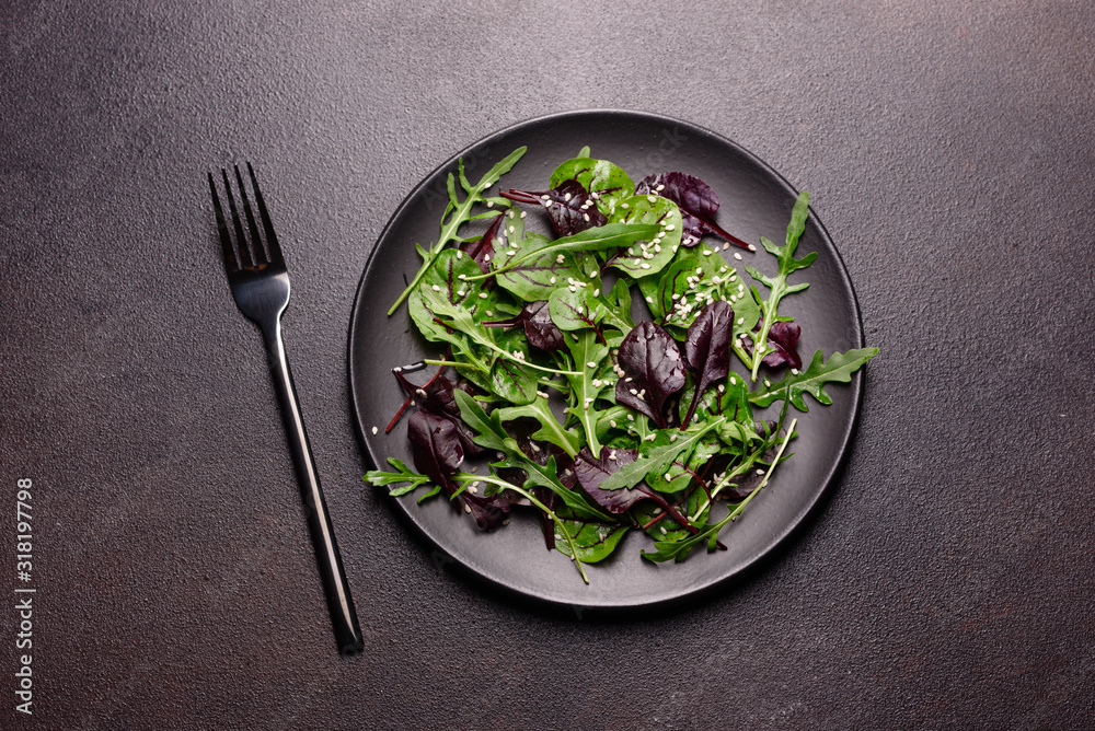 Healthy food, salad mix with arugula, spinach, bulls blood, beet leafs and micro greens Healthy food, salad mix with arugula, spinach, bulls blood, beet leafs and micro greens