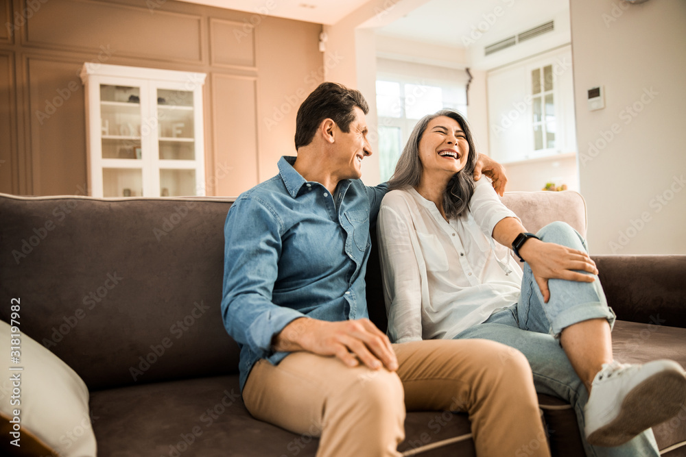 Happy pretty woman laughing with her husband at home