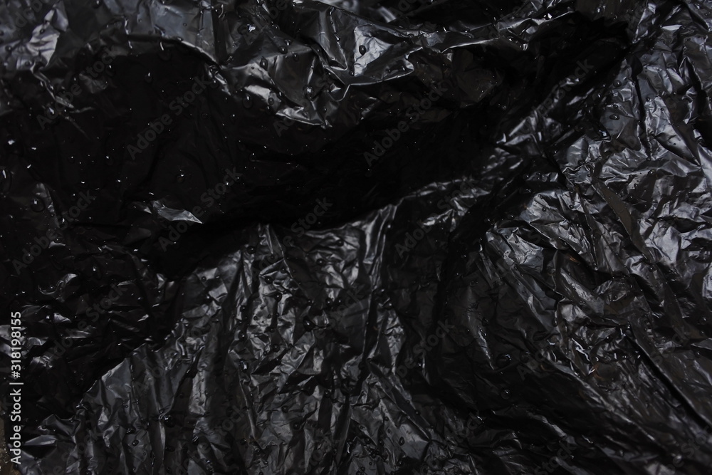 black plastic bag on dark background