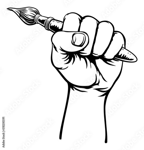 A fist hand holding an artists paintbrush in a vintage intaglio woodcut engraved or retro propaganda style