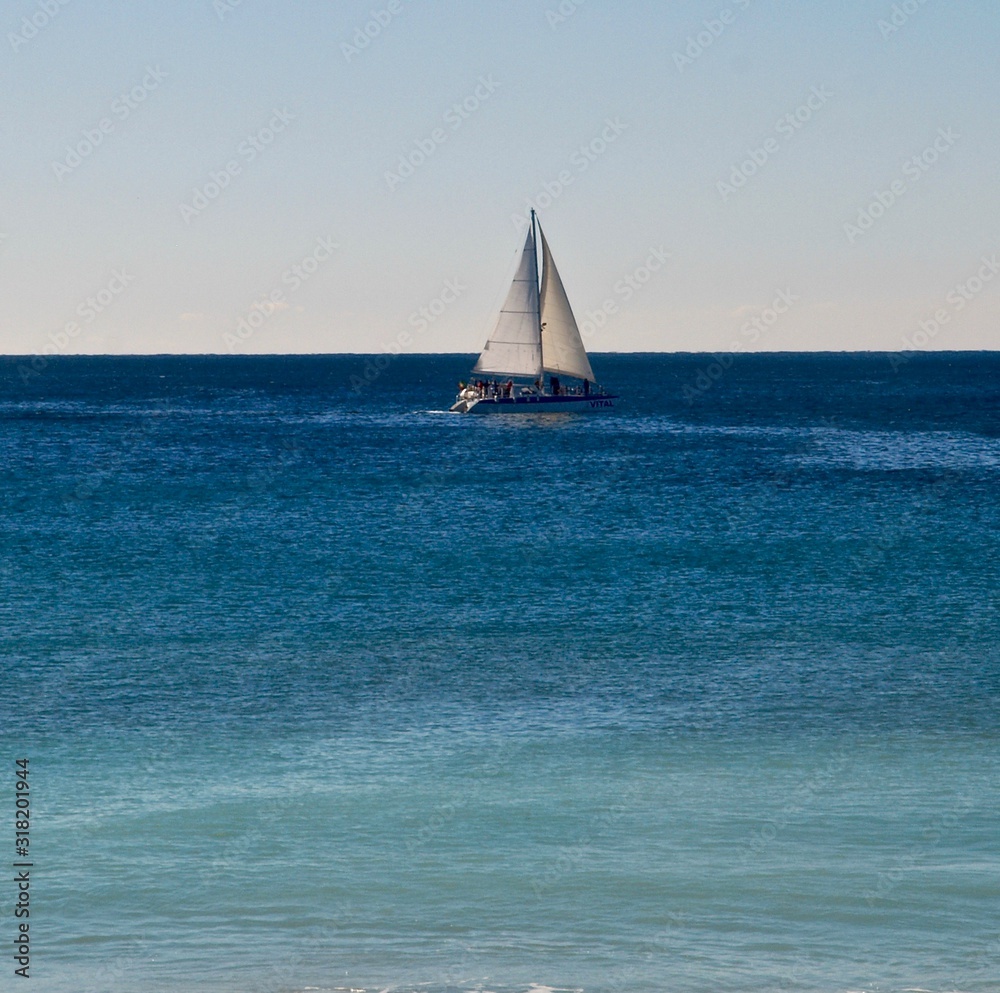 White sailboat on the blue Atlantic ocean