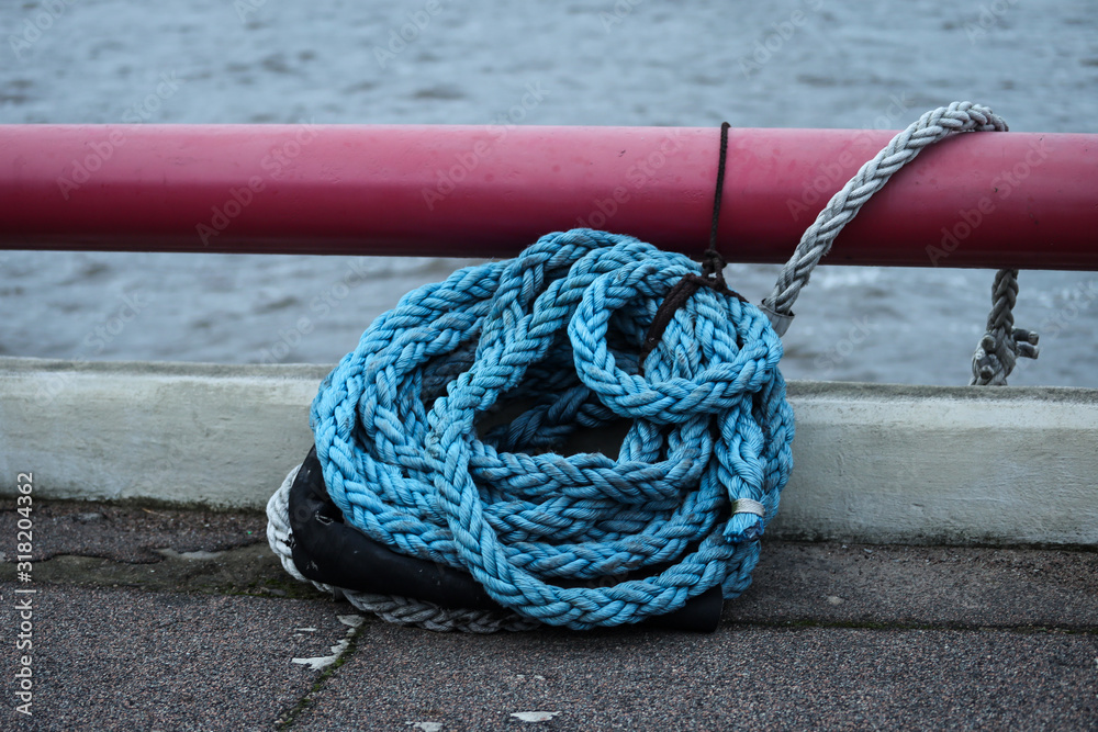 Fototapeta premium Blue strong shipping boat rope for big ship docking.