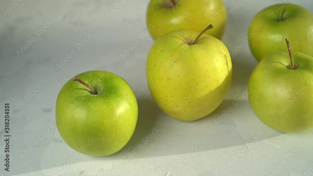 Green and yellow apples on white concrete background. Recipe, cooking, diet concept. Close-up Green and yellow apples on white concrete background. Recipe, cooking, diet concept. Close-up