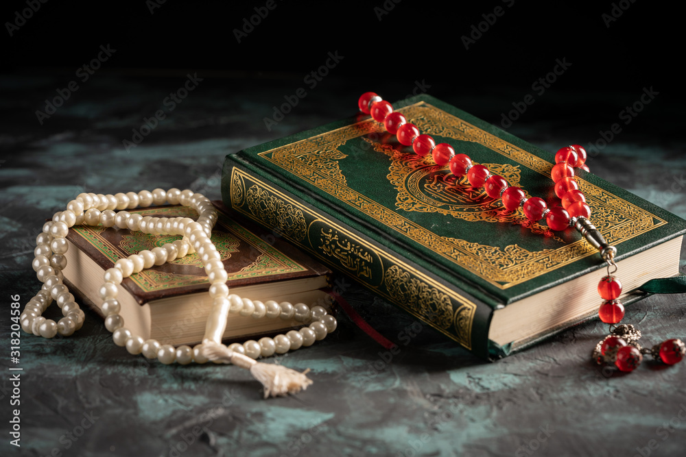 Islamic concept: The holy Quran and Tasbih (rosary beads) on dark ...