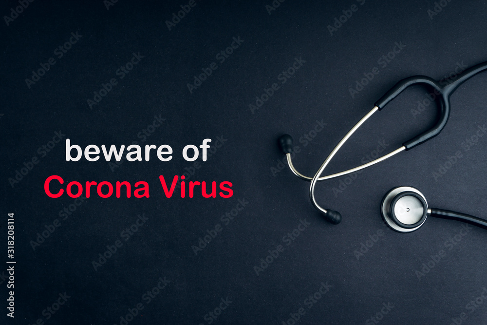 Stethoscope with words BEWARE OF CORONA VIRUS on black background. Selective focus and crop fragment