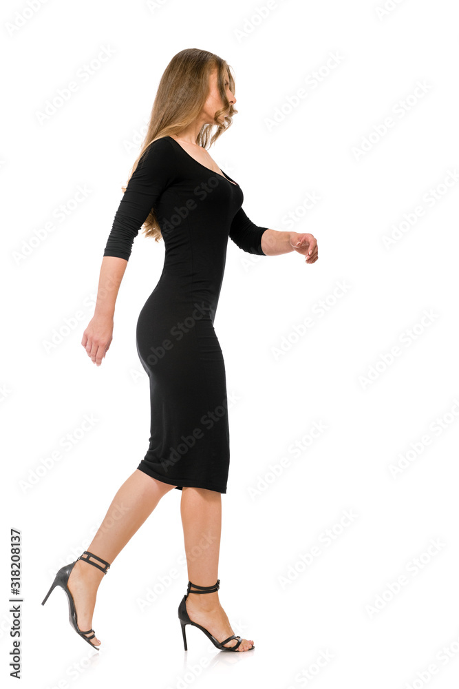 Side view of fit slim woman in black dress walking on white background  Stock Photo | Adobe Stock