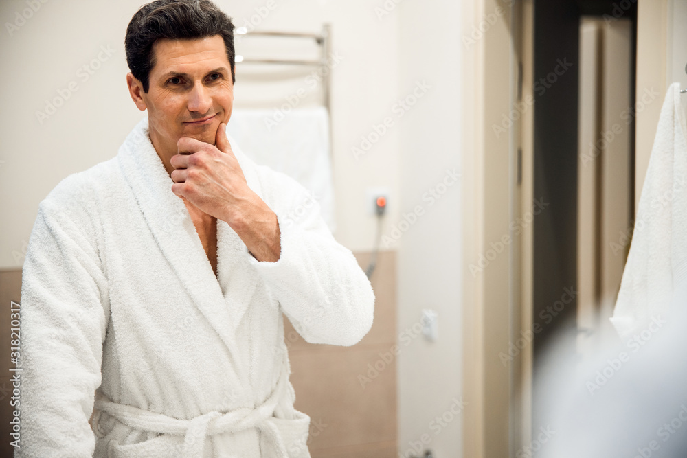Smiling man posing in bathroom at home