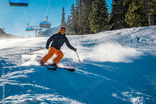 Young skier braking with a smile on his face