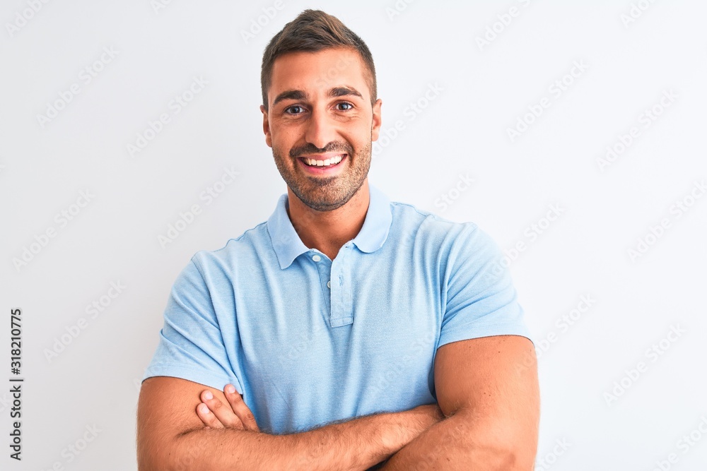 © Krakenimages.com - Young handsome elegant man wearing blue t-shirt over isolated background happy face smiling with crossed arms looking at the camera. Positive person. © Krakenimages.com - Young handsome elegant man wearing blue t-shirt over isolated background happy face smiling with crossed arms looking at the camera. Positive person.