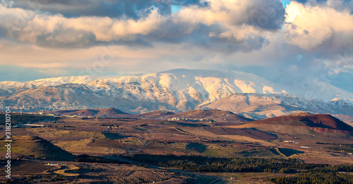 Snow on Hermon mountain with blue sky and clouds landscape view photo