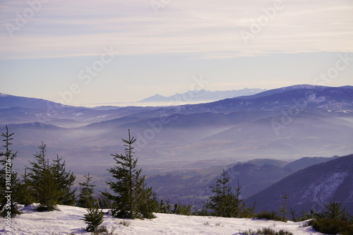 Panoramic view of winter and snowy landscape from the observation platform at the peak of a mountain in Szczyrk, Skrzyczne localization Beskid Mountains. Screensaver, copyspace or natural background.