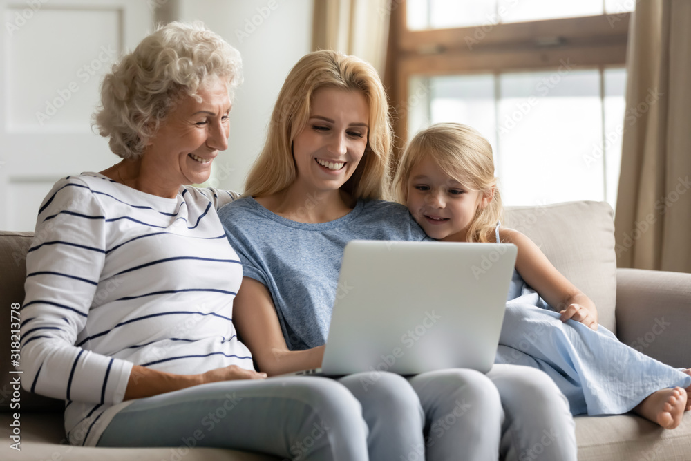 Joyful three generations family shopping online at home. Joyful three generations family shopping online at home.
